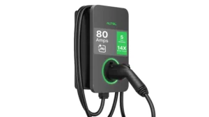 Autel MaxiCharger 80A EV Charger mounted on a white wall with J1772 connector plugged in, green display, and coiled charging cable.