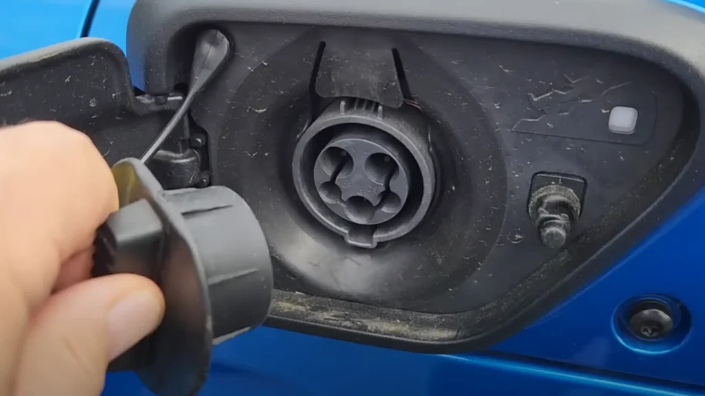 Close-up of the Jeep 4xe J1772 charging port open with the protective cover removed, ready for connection.