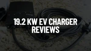 A 19.2 kW Emporia Pro EV Charger and its coiled black cable are displayed on the Electric Vehicle Geek EV Charger test bench countertop. The text "19.2 KW EV CHARGER REVIEWS" is overlaid in bold white letters.