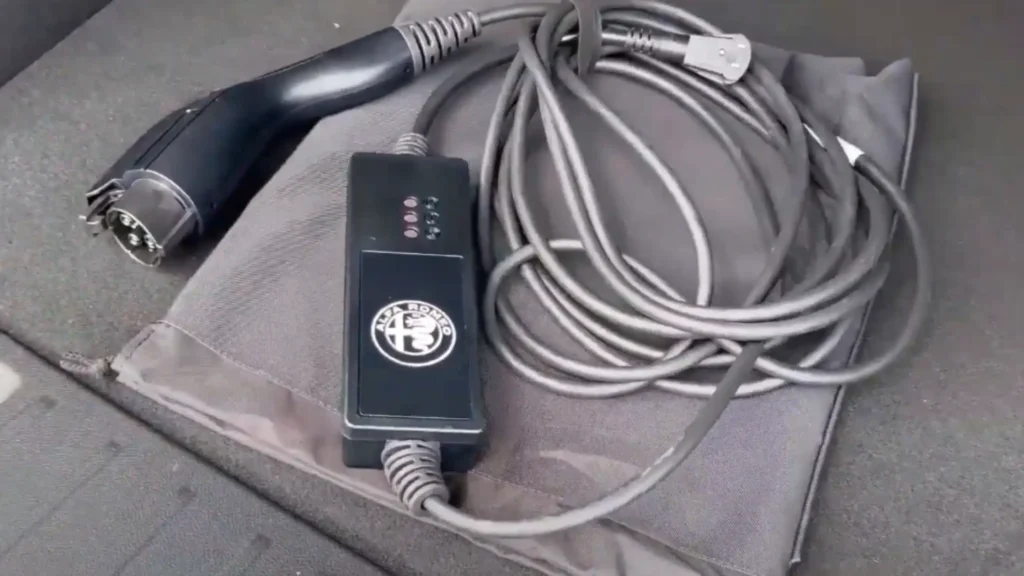 Alfa Romeo Tonale OEM Level 1 charger with SAE J1772 connector, the image shows a branded control box and the charger carrying case.