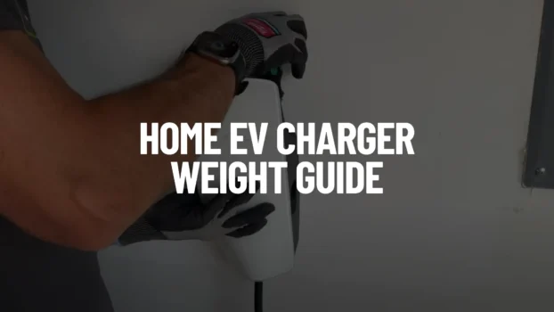 A close-up photograph of an installer wearing gray work gloves and a smartwatch mounting a sleek white Tesla Wall Connector EV charger to a garage wall. The image features a dark overlay with large, bold white text in the center that reads 'HOME EV CHARGER WEIGHT GUIDE'.
